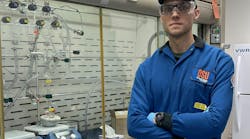 Artiom Skripka in front of a fume hood where the scientists synthesize their nanomaterials.